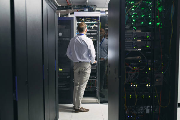 istock Rearview shot of a mature man working in a server room 1343548825