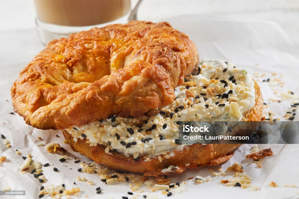 Cheese Bagel with Cream Cheese and Everything Bagel Seasoning Toasted Cheese Bagel with Cream Cheese and Everything Bagel Seasoning Bagel Stock Photo