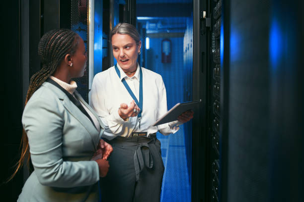 istock Shot of two young IT specialists standing in the server room and having a discussion while using a digital tablet 1343550679