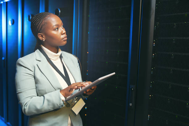 istock Shot of a young IT specialist standing alone in the server room and using a digital tablet 1343550692