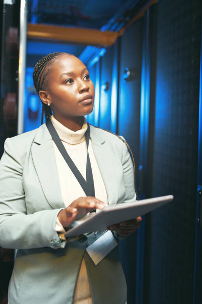 istock Shot of a young IT specialist standing alone in the server room and using a digital tablet 1343550695