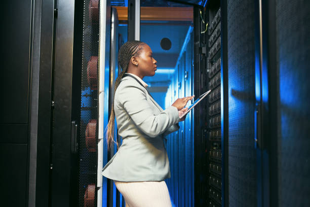 istock Shot of a young IT specialist standing alone in the server room and using a digital tablet 1343550701