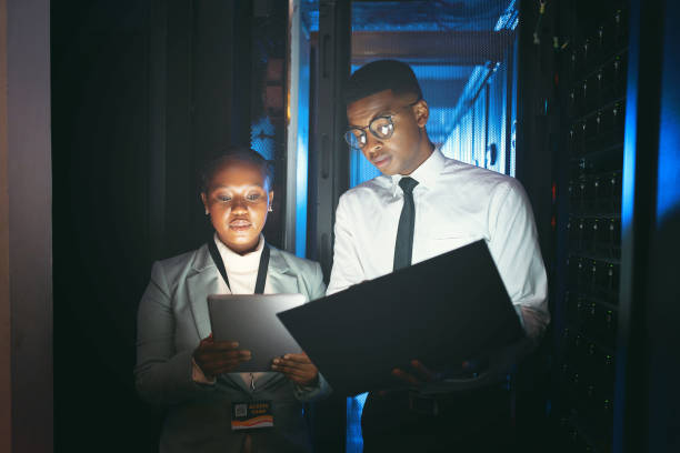 istock Shot of two young IT specialists standing in the server room and having a discussion while using a technology 1343550704