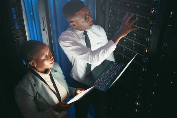 istock Shot of two young IT specialists standing in the server room and having a discussion while using a technology 1343550711
