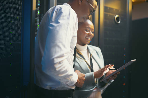istock Shot of two young IT specialists standing in the server room and having a discussion while using a digital tablet 1343550714