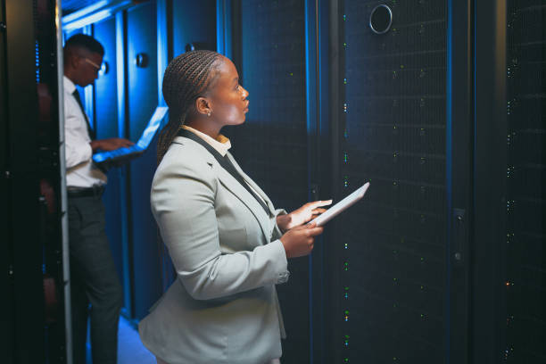 istock Shot of two young IT specialists standing together in the server room and using technology 1343550733