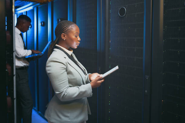 istock Shot of two young IT specialists standing together in the server room and using technology 1343550734