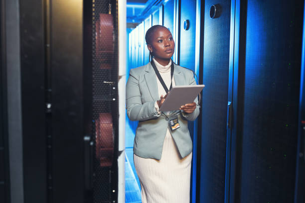 istock Shot of a young IT specialist standing alone in the server room and using a digital tablet 1343550738