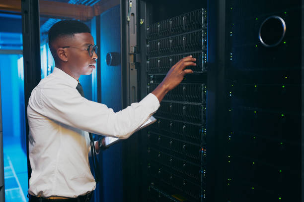 istock Shot of a young IT specialist standing alone in the server room and using a digital tablet 1343550746