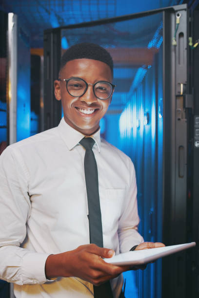 istock Shot of a young IT specialist standing alone in the server room and using a digital tablet 1343550756