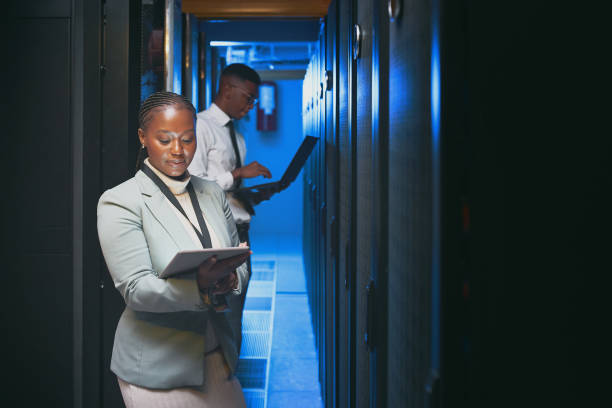 istock Shot of two young IT specialists standing together in the server room and using technology 1343550773