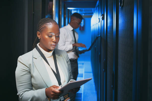 istock Shot of two young IT specialists standing together in the server room and using technology 1343550789