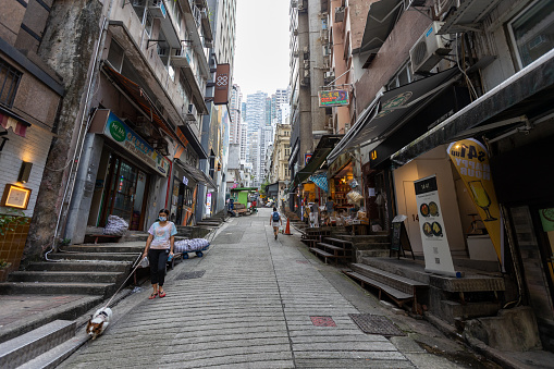 Hong Kong - September 28, 2021 : People walk past the Peel Street in Central, Hong Kong. It is named after Robert Peel, the two-time British prime minister. The road was built in the 1840.