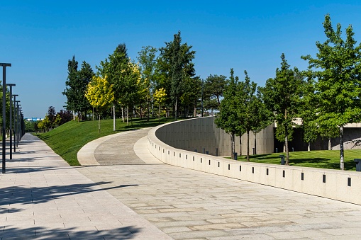 Multilevel landscaped city park 'Krasnodar' or 'Galitsky park'  with ornamental trees and green lawn on slopes. Best place in city for relaxation and walking. Krasnodar,