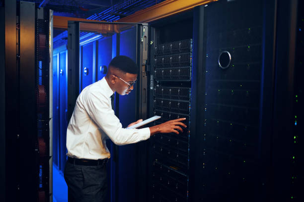 istock Shot of a young man using a digital tablet while working in a server room 1343553186