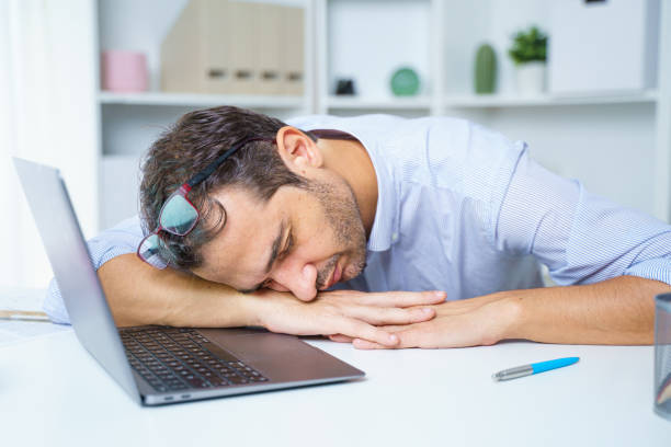 One unproductive lazy worker sleeping in workplace Exhausted tired businessman sleeping in front of his laptop narcolepsy stock pictures, royalty-free photos & images