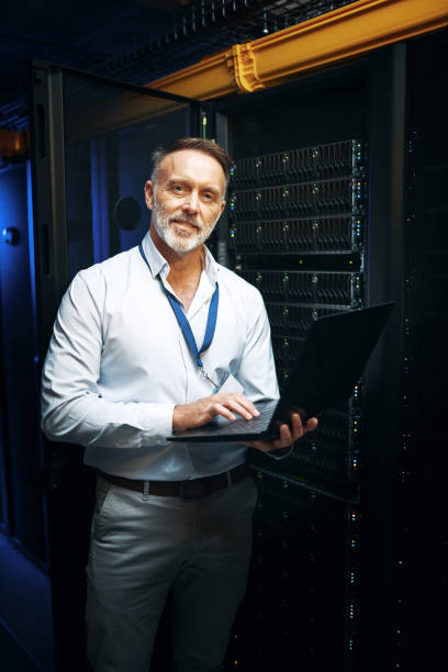 istock Portrait of a mature man using a laptop while working in a server room 1343553248
