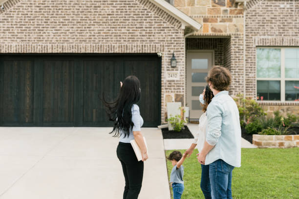 istock Agent gestures toward new home family is going to view 1343554407