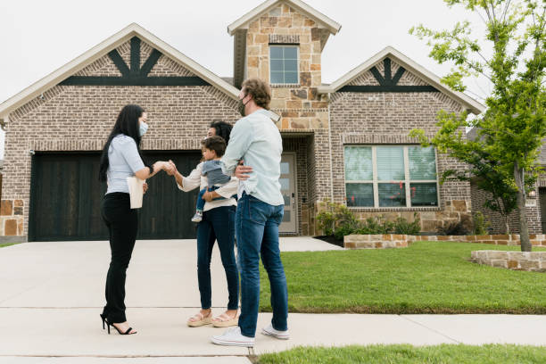 istock Agent shakes hands with woman as husband waits 1343554408
