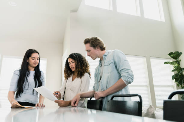 istock While real estate agent waits, couple discusses contract 1343554446