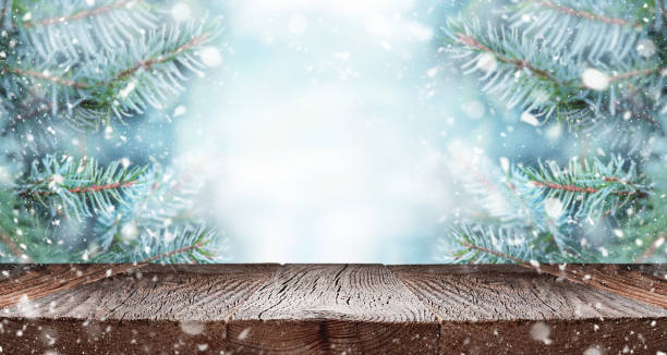 istock Empty wooden table over branches of fir tree with snow. 1343555857