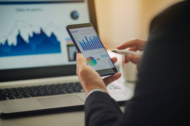istock businessman working on project for analyzing company financial report balance statement with documents graphics at modern office space. Concept picture of business,economy, market,money and tax. 1343557262