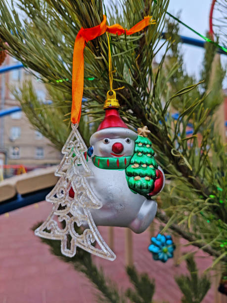istock Plastic tree and Glass snowman with Christmas tree hanging on the Christmas tree 1343557498