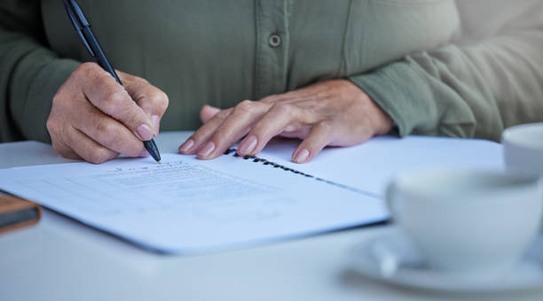 istock Shot of an unrecognizable businessperson going through paperwork at work 1343557632