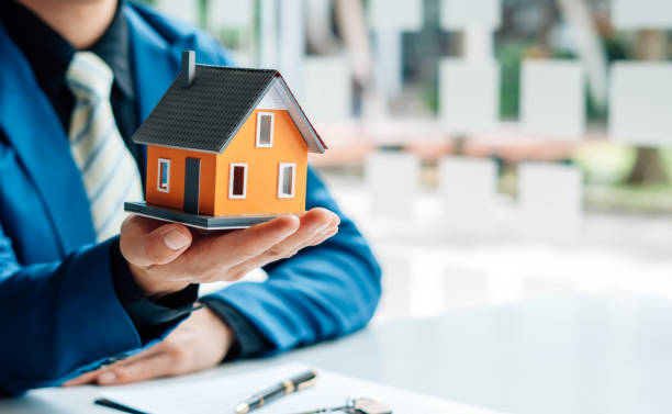istock Buying a Home or Insurance, an insurance agent explains the lease agreement to a client before making a contract. Mortgage loan approval home loan and insurance concept. 1343557773