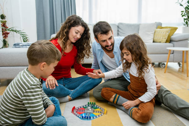 istock Cheerful parents playing board game with their children. 1343558709