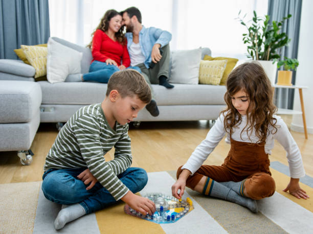 istock Cheerful children playing board games. 1343559129
