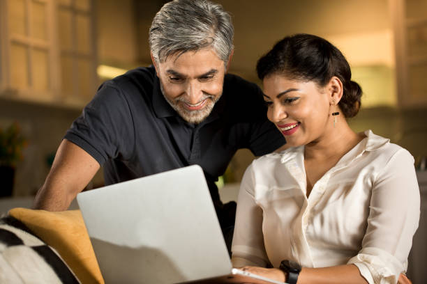 istock Couple using laptop at home 1343560798