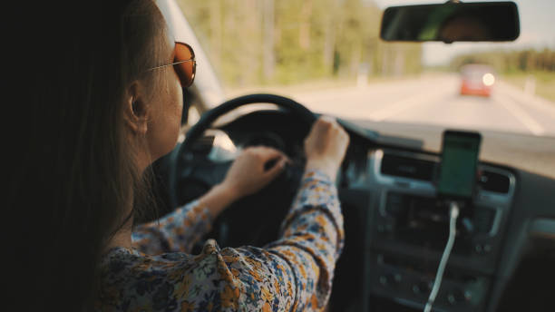 istock Woman driving a car in summer time. 1343562469