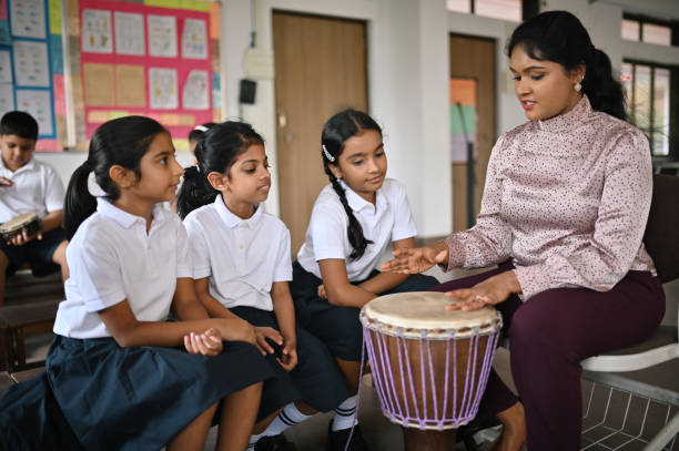 istock Teacher teaching to play Bongo to children in school 1343562802