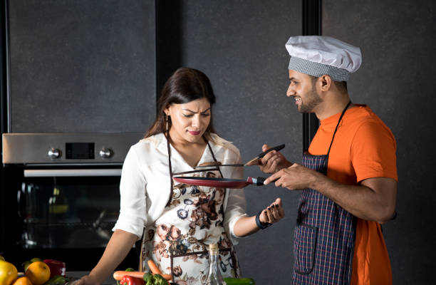 istock Couple having fun while cooking food in kitchen 1343563082