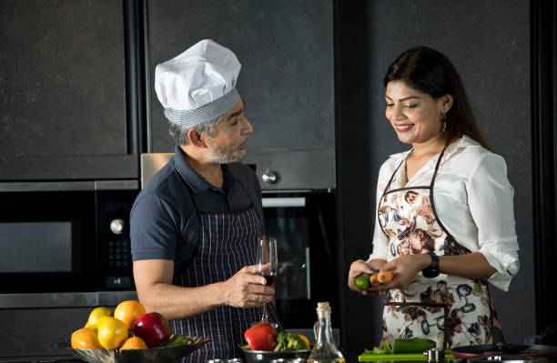 istock Happy couple enjoying champagne while cooking food in kitchen 1343563147