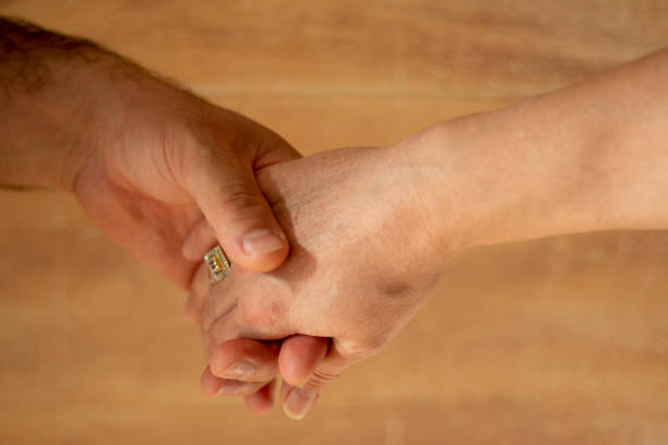 istock Two touching hands reach out to each other 1343563501