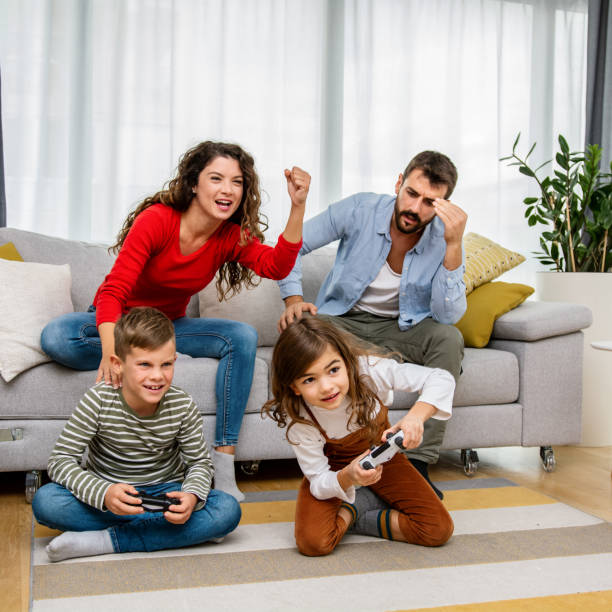 istock Family playing video games at home 1343564701