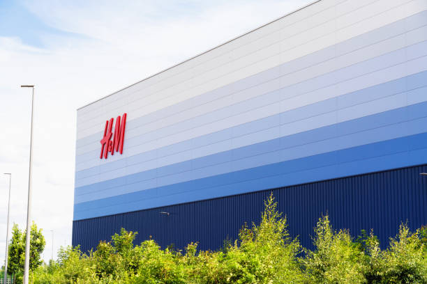 H&M Distribution Centre Milton Keynes, UK - The exterior of a large, modern H&M distribution warehouse, located close to the M1 Motorway. h and m stock pictures, royalty-free photos & images