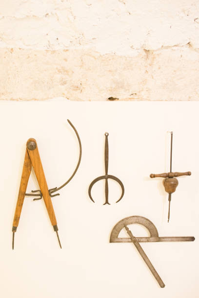 Ancient wooden tools for drawing, measuring  and construction activities.Tools hanging on a wall. Museum at Teruel, Aragon, Spain, Europe