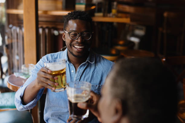 istock Father and son toasting and drinking beer in the pub 1343565847