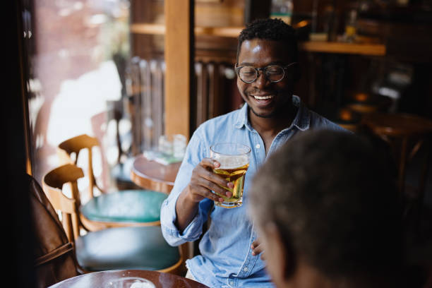 istock Father and son toasting and drinking beer in the pub 1343565858