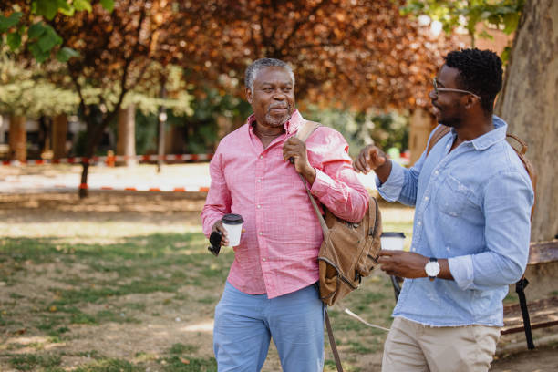 istock Father and son on a walking through the park with coffee to go 1343565985