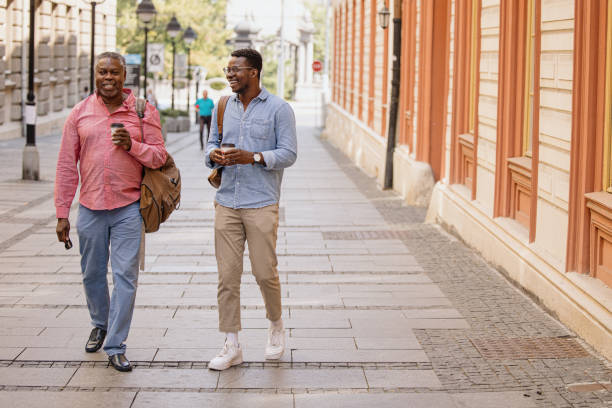 istock Father and son bonding time, drinking coffee to go while walking 1343566202