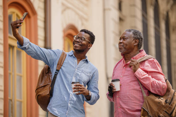 istock Father and son taking a selfie while walking the city streets 1343566205