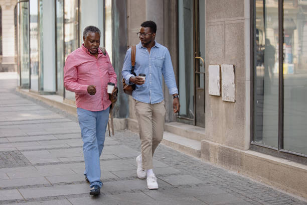 istock Father and son bonding time, drinking coffee to go while walking 1343566216