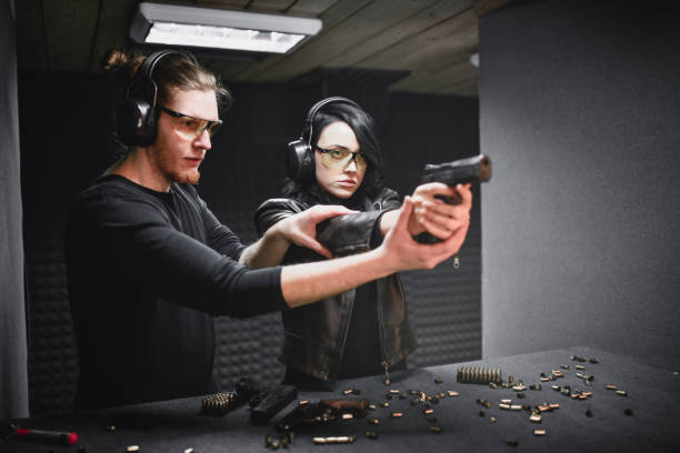 istock Firearms Instructor Helping Female Learn The Basics On Firing Range 1343566286