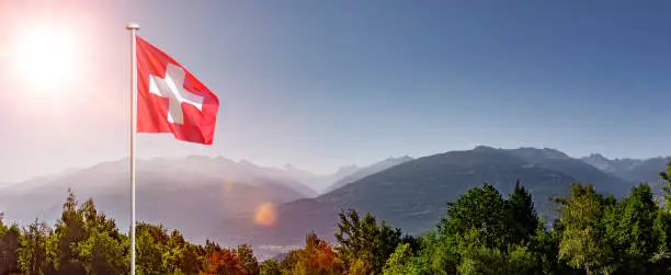 Swiss flag in Valais in front of Rhone valley
