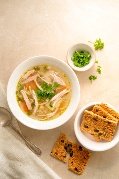 istock Chicken noodle soup, vegetable soup with crispbread. 1343574893