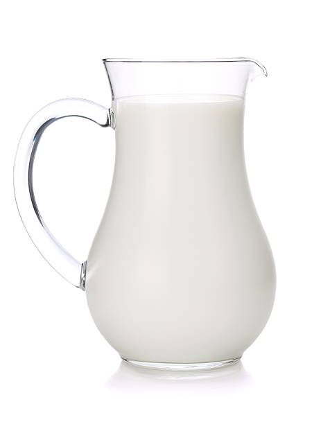 istock Glass jug of milk on white background 134357602